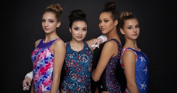 Four girls in gymnastics leotards