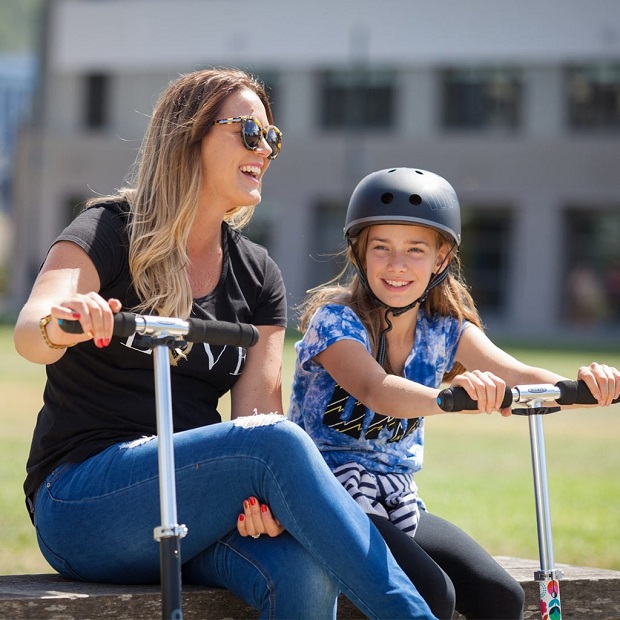 mom and kid sitting happy with scooters