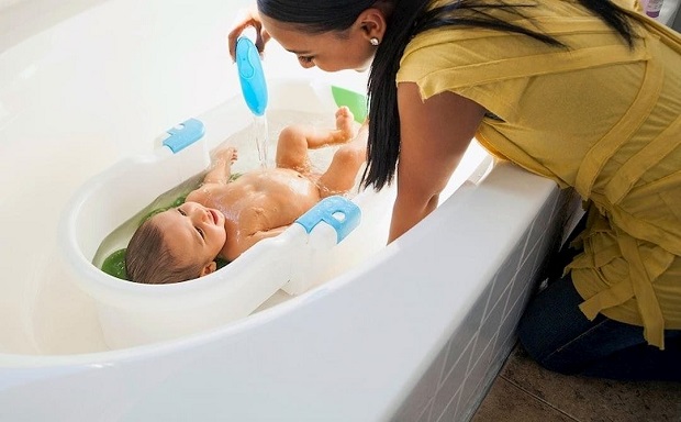 picture of a mother bathing a baby in a toddler bath tub