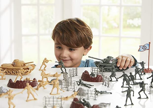boy playing with military toys